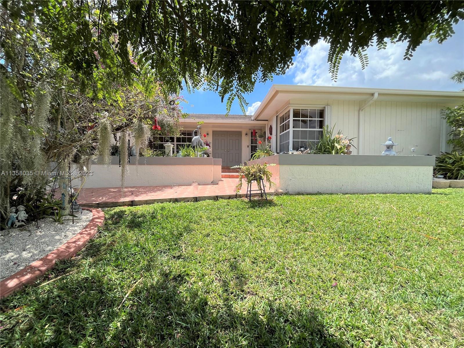 Immaculate family home located minuets from Black Point Park and Marina, and the Turnpike. Come visit this one story four-bedroom two-bathroom home with enchanted Zen gardens. Spacious design with high ceilings, both formal and informal gathering areas and a bonus large, covered terrace. An open den and kitchen combination is perfect for family time.  The kitchen is complete with an eat in island, garnet counter tops and stainless-steel appliances.   Relax in an oversize master bedroom with private en suit bathroom which includes a vanity make up area.  The second bathroom is updated with all the bells and whistles including a back-lite vanity mirror. This corner lot is 10,491 SF, one of the largest lots in the neighborhood.