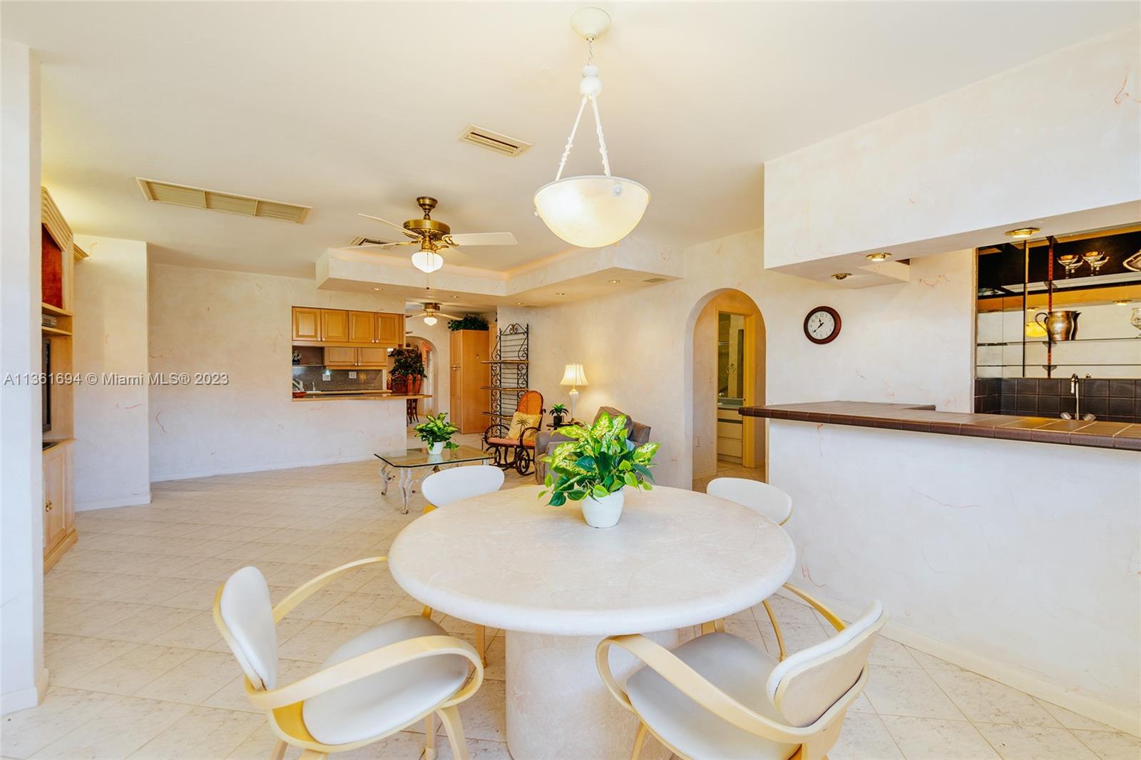 Great room with wet bar looking onto the kitchen.
