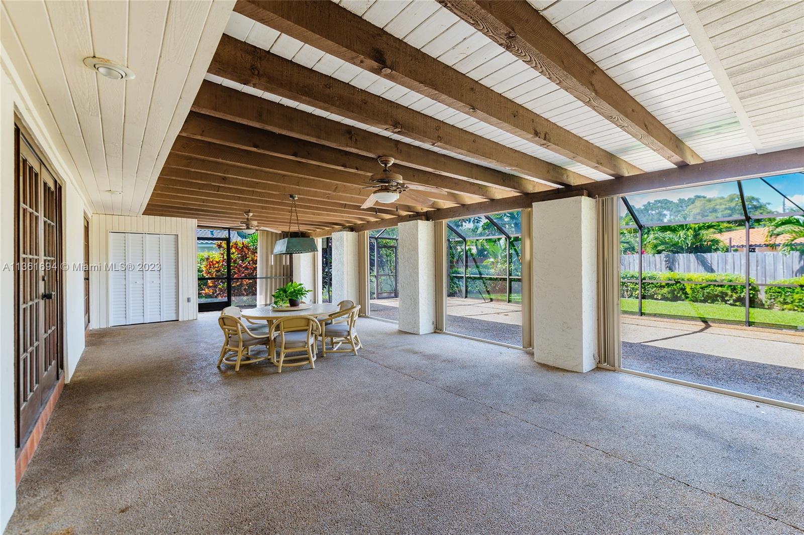 Large covered patio with accordion shutter protection.
