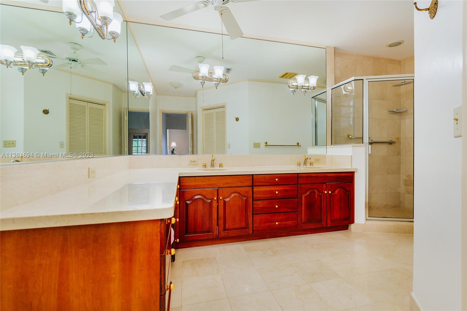 Double sinks with vanity area and shower

