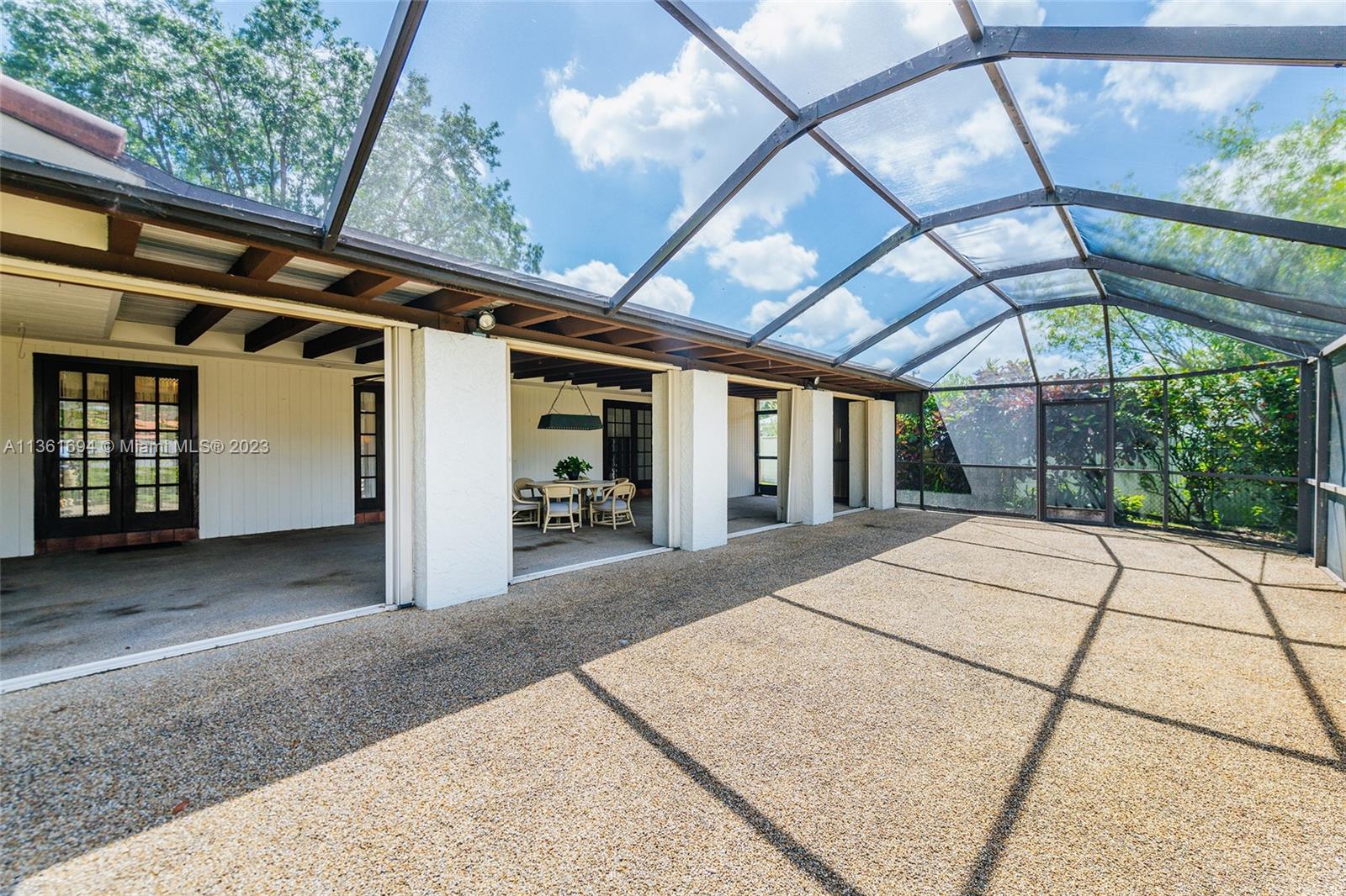 Screened patio area adjacent to covered patio.