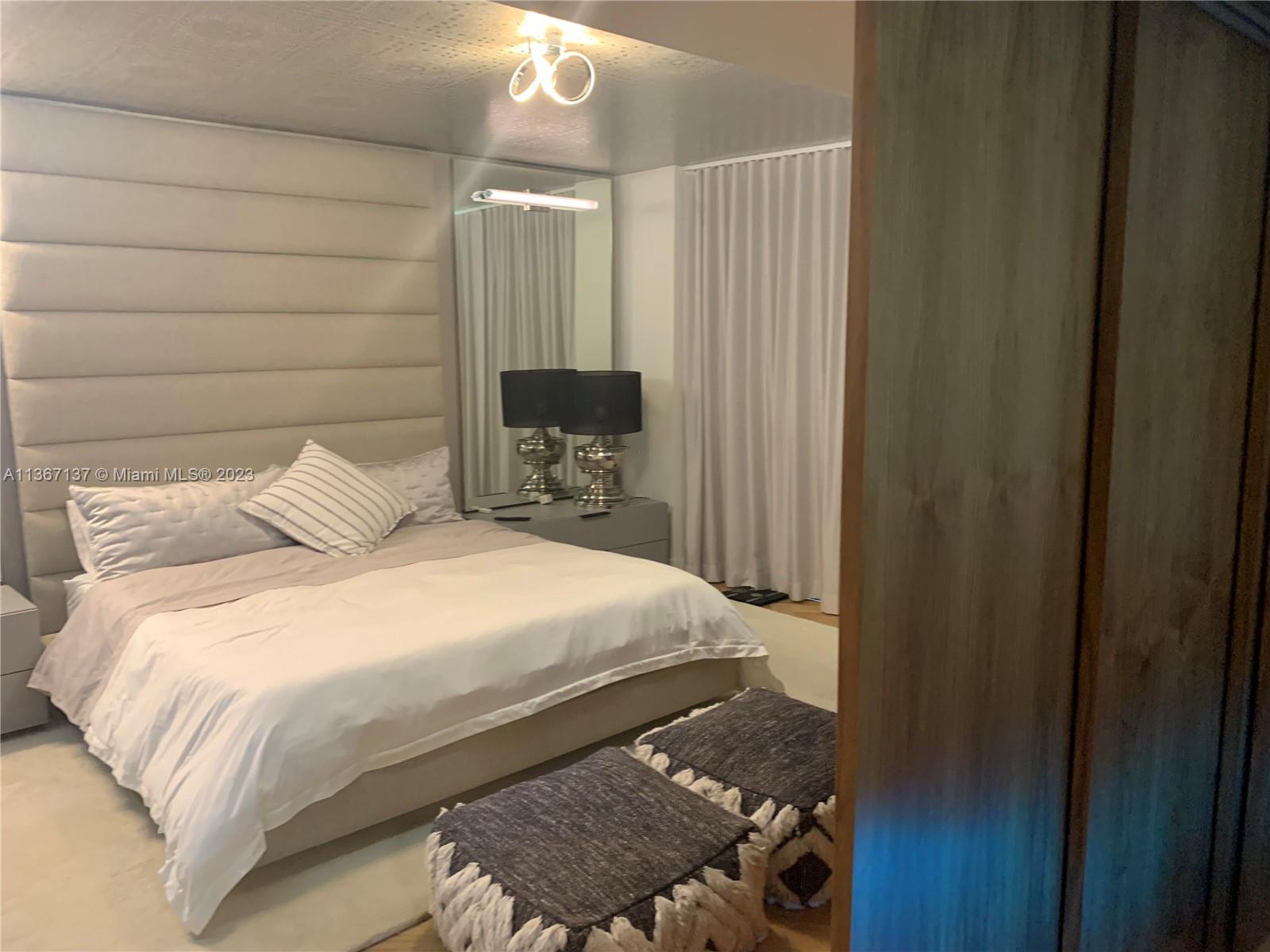 Master Bedroom with Japanese walnut wood hanging doors half open.