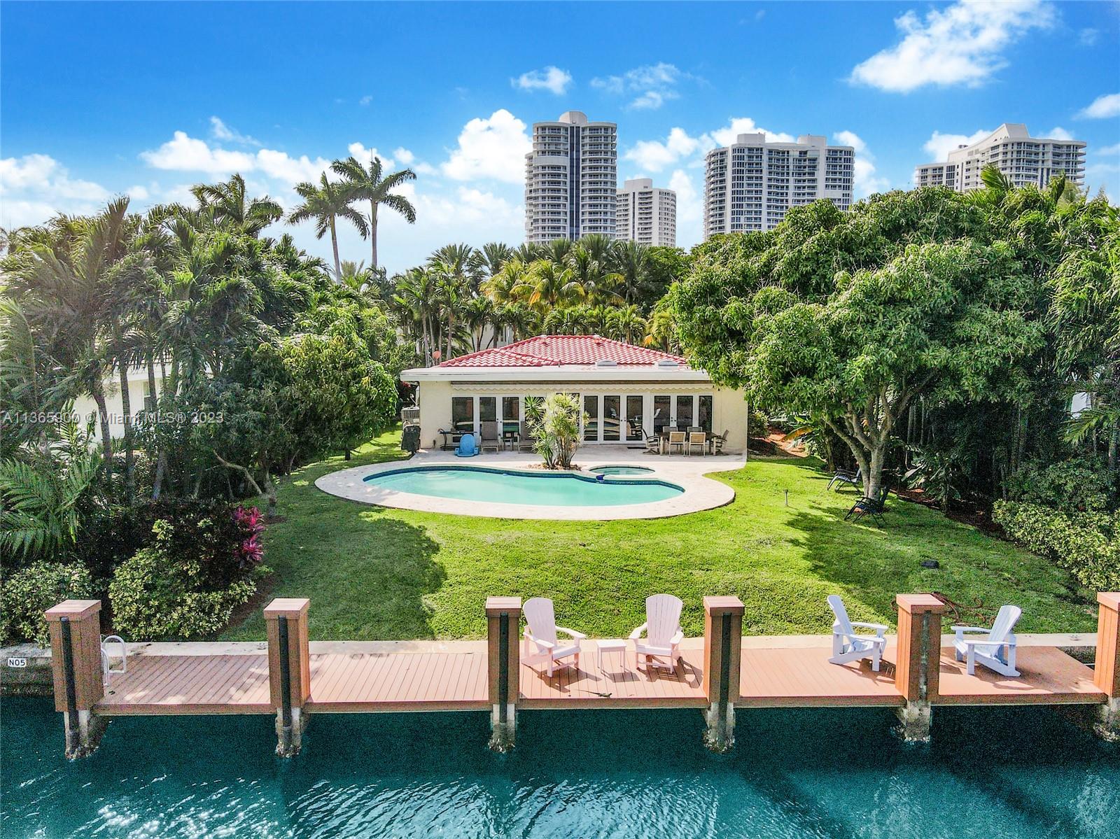 Golden Beach-Exclusive Gated Community with Private Beach.  Spacious 1-Story waterfront gem located on a quiet cul de sac on prestigious North Island.  Highlights include Spacious floorplan with marble and porcelain wood floors throughout, renovated kitchen and baths, brand new roof, and impact glass windows and doors. Great backyard with heated pool and jacuzzi, retractable awning and private newer dock on prime 75feet of water frontage. Enjoy living in this tropical beach bungalow or build your dream home on this fabulous 12,000sf lot. Golden Beach will be renovating and expanding one of its multiple parks that will feature tennis courts, pickleball courts, Junior basketball court, doggie parks, and a future Wellness Center and Gym. Den can be converted to 4th bedroom.