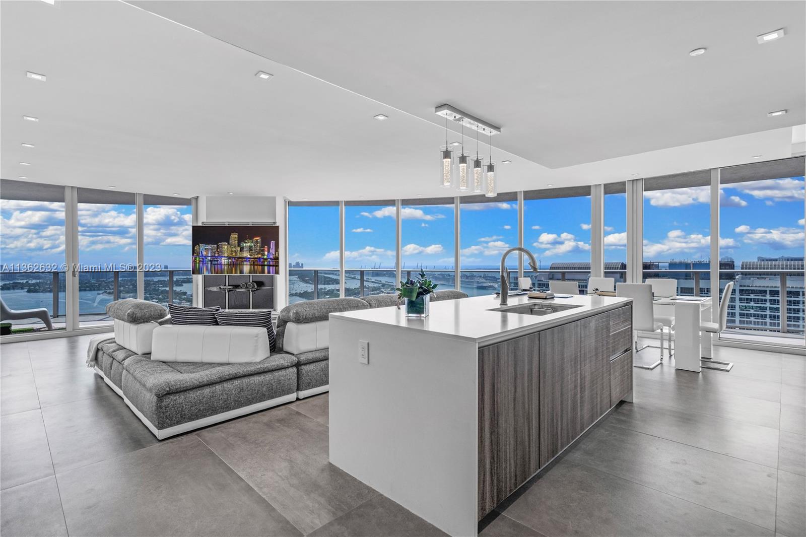 This luxurious corner unit on the 39th floor at Aria On The Bay boasts breathtaking direct water and city views of the Miami Skyline and unparalleled comfort. With 2 private elevators, a private foyer, 3 bedrooms, a den, and 4 bathrooms, this unit offers convenience and style. Enjoy stunning views from the large wrap-around terrace and spacious living area with floor to ceiling windows. Upgrades abound, including the Vogue Collection by Lineaire Designs, upgraded kitchen, premium texture closets, and motorized solar shades. Two tandem parking spaces on the lowest garage floor add to the convenience. Experience full-service luxury amenities at Aria On The Bay. Schedule a viewing today!