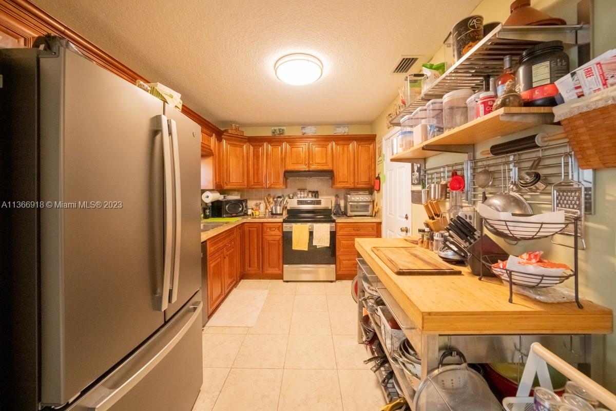 IKEA kitchen and SS appliances that are under warranty. Granite countertops.  Additional butcher block table can stay.  You can enter the kitchen from the garage.