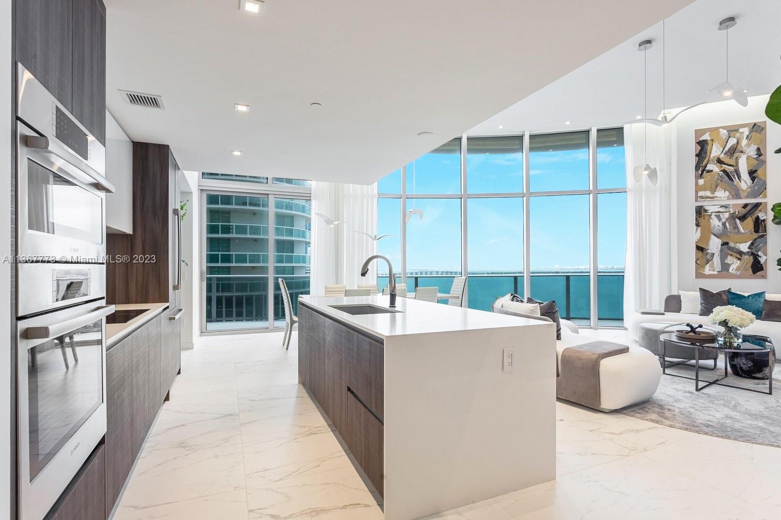 Eyperience luxury living at its finest in this spectacular "ONE OF A KIND" residence. Very a unique and sought-after line, with only 4 in the building with extra high ceilings. This high standard designer decorated 3 bed plus Den 4 bath reatures extra deep ba conies wdirect east water views. Private elevator tover. toor-to-ceiling windows + doors. Custom Designed European kitchen w/Bosch appliances, open living floor plan. No expenses have been spared.