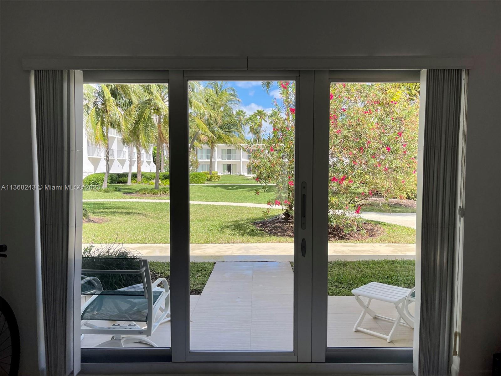 View to garden from living area. Best quality high impact sliding doors invite you to the patio and garden pool area.