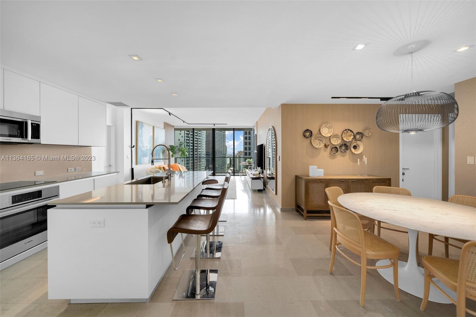A beautifully designed 3 Bed + Den/3.5 Bath condo at Reach Brickell City Centre w/ 2,066 interior square feet (per developer floor plan), kitchen & bathroom cabinetry by Italkraft, Bosch kitchen appliances, front-loading washer & dryer, motorized shades on all windows, tons of custom built-ins for additional storage, and floor-to-ceiling glass windows w/ direct views of the bay & city from the 21st floor. $250K in upgrades. Includes one assigned parking space w/ a dedicated EV charging station. Building amenities include lap & social pools, two hot tubs, fitness center, children's play areas, full-service spa w/ hammam, BBQ grills, clubroom, business center, full-service concierge, and 24-hour valet parking service. Restaurants, stores, and entertainment at your doorstep.