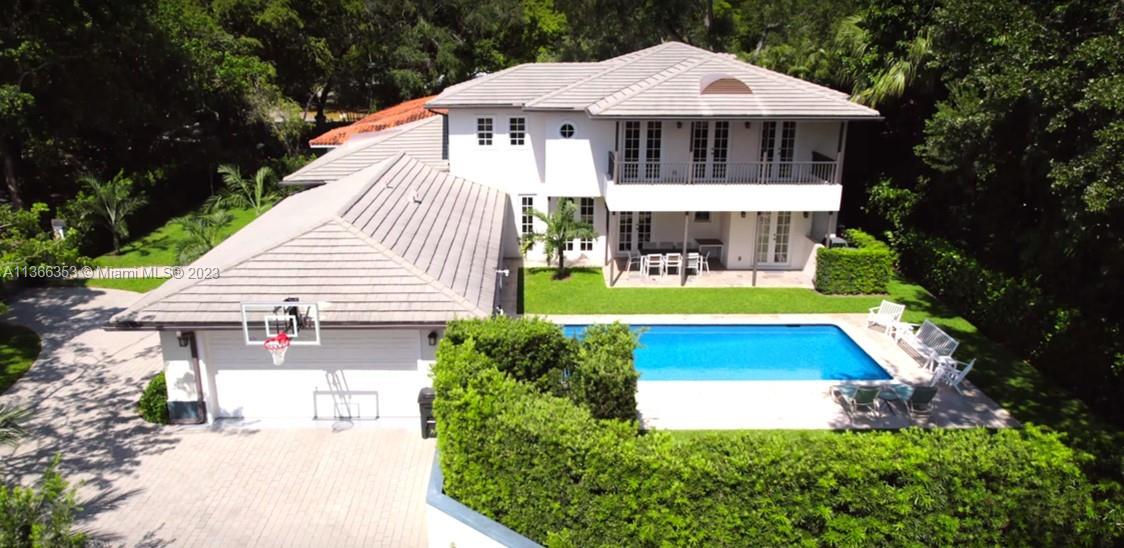 Large pool and patio in lush, private and gated back yard