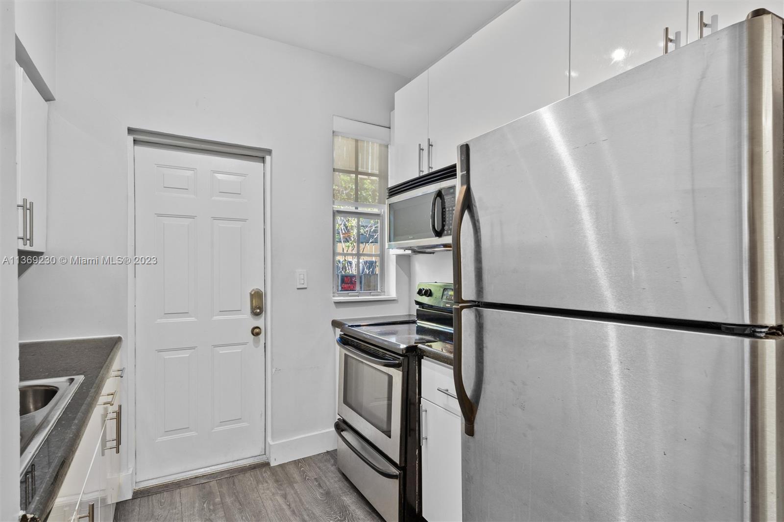 Renovated kitchen with granite counters & stainless steel appliances