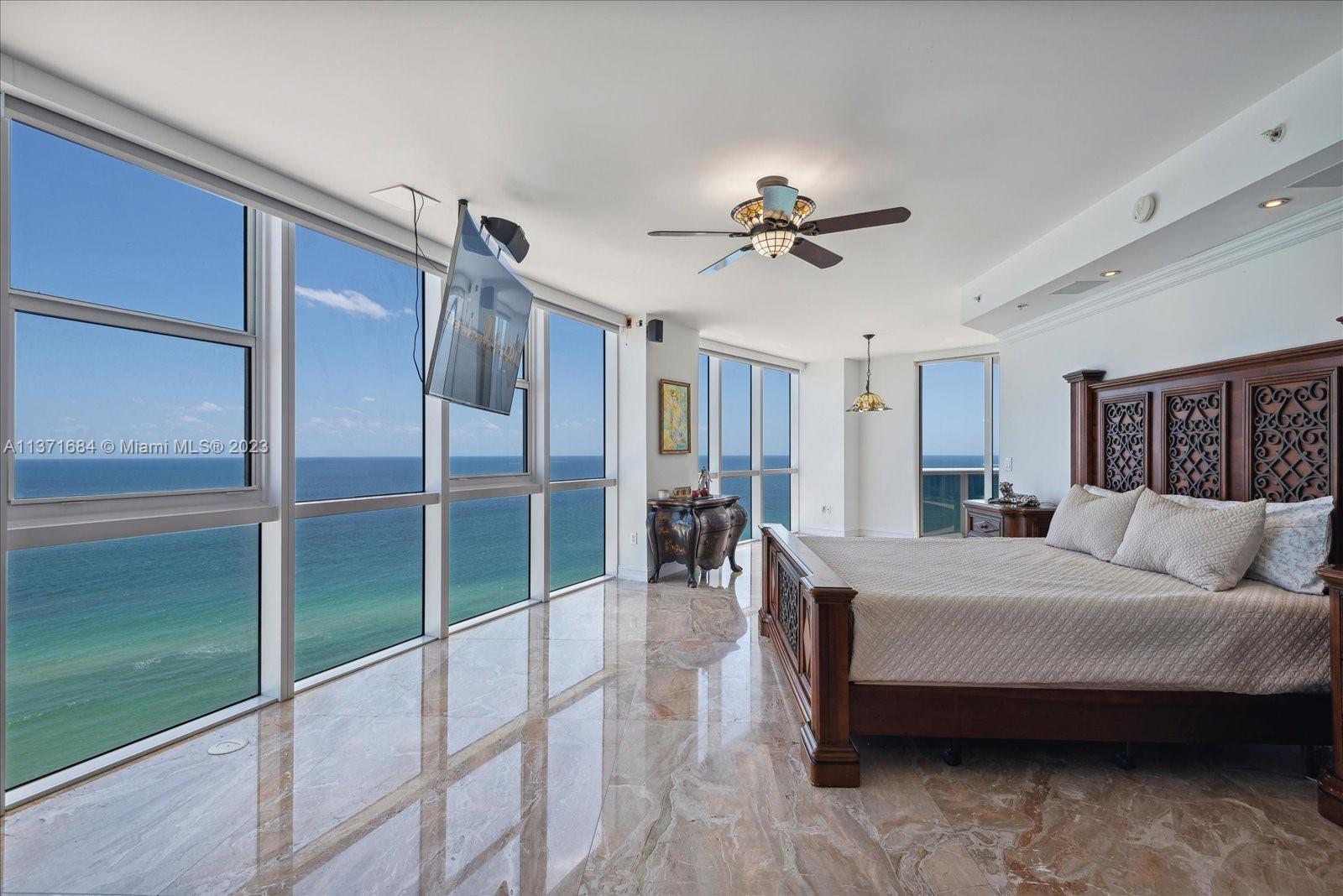 Master Bedroom whole wall with floor to ceiling window facing Ocean - wake up to this view everyday