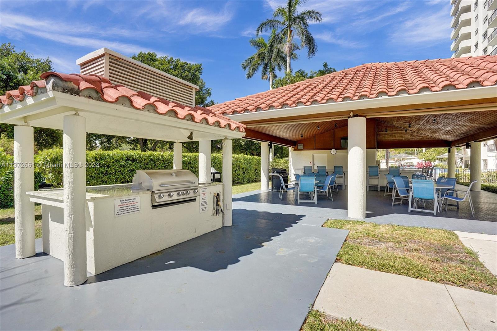 covered cabana area by pool with 2 BBQ's