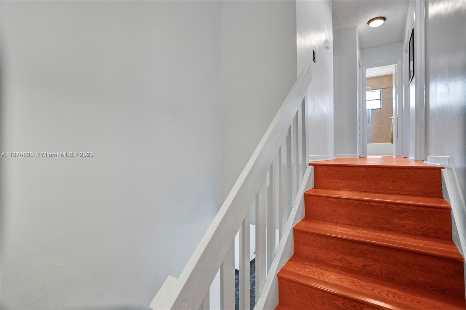 Wood stairwell with a landing.