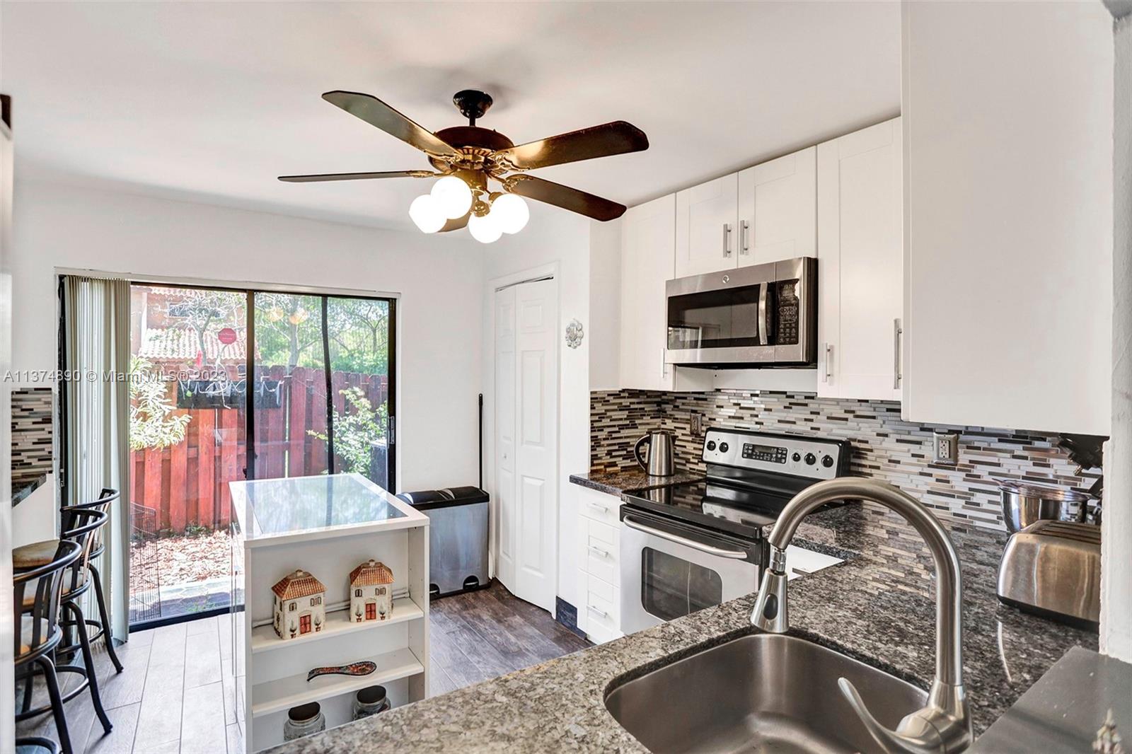 Remodeled kitchen with all new appliances, granite counter tops, glass backsplash and white cabinetry*