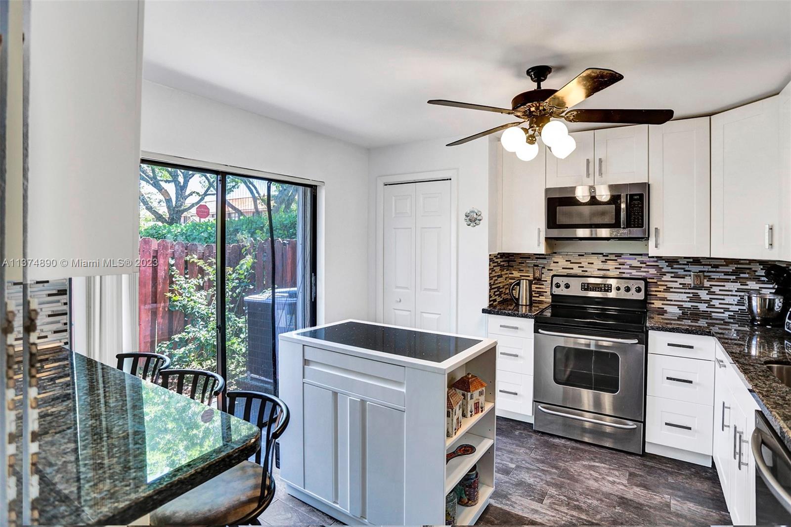 Room for an island and extra cabinetry on one side with a snack bar.