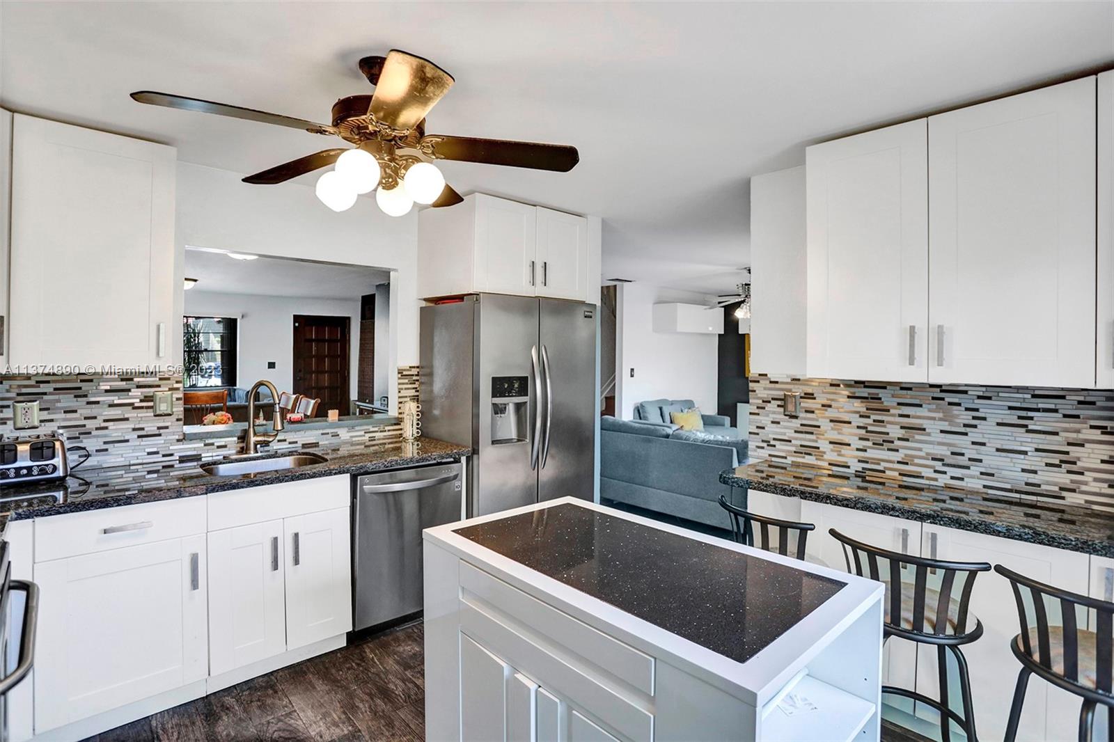 Another view of the spacious white kitchen.