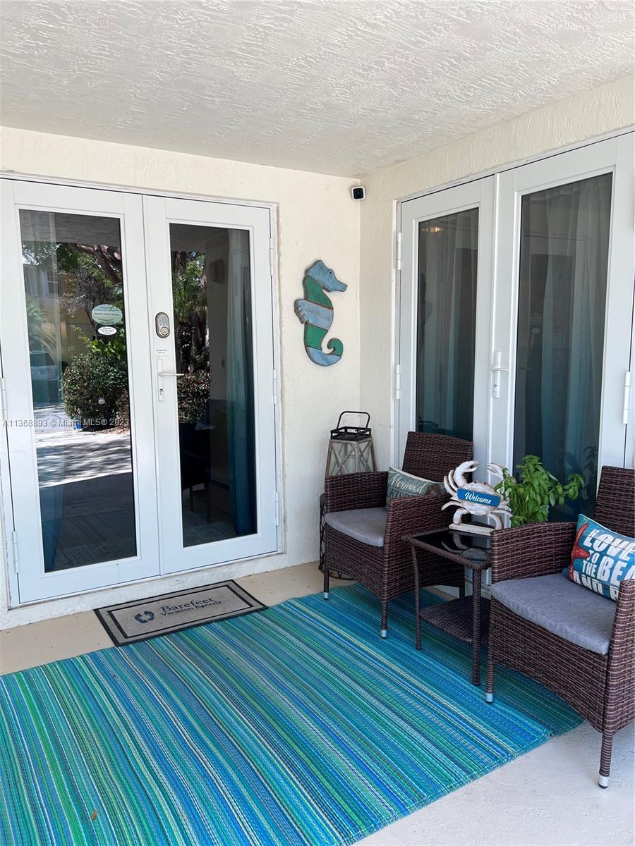 2nd level view from staircase landing.  Main living area consists of a spacious dining room and Kitchen, living room, 1/2 bath and screened in porch.