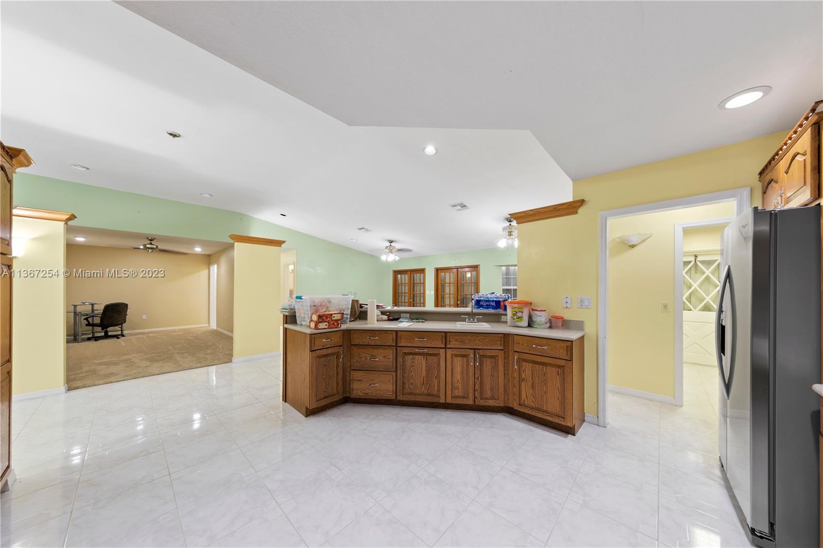 KITCHEN  COUNTER BAR  WITH VIEW OF FORMAL DINING N LAUNDRY ROOM