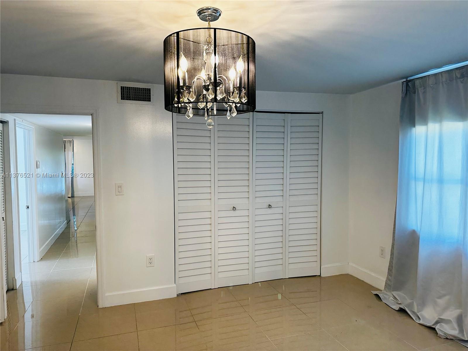 Master Bedroom with beautiful light fixture