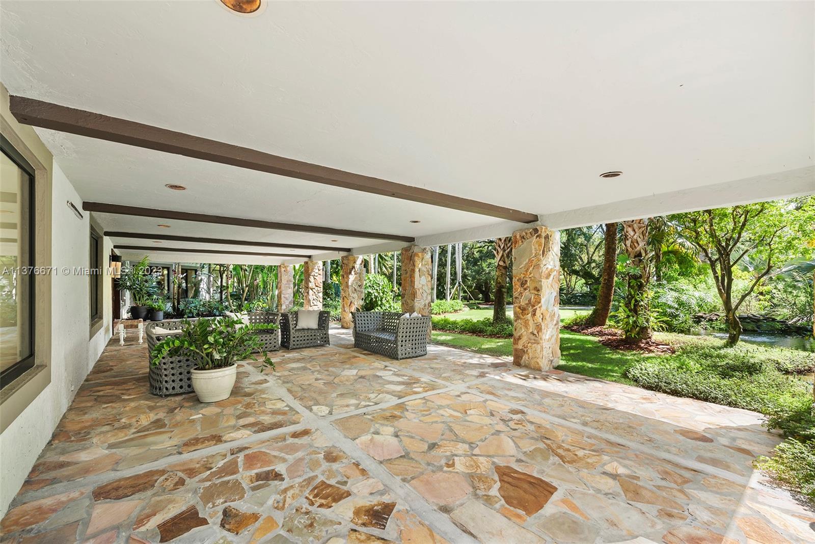 Sprawling Front Terrace Overlooks Winding Fish Pond