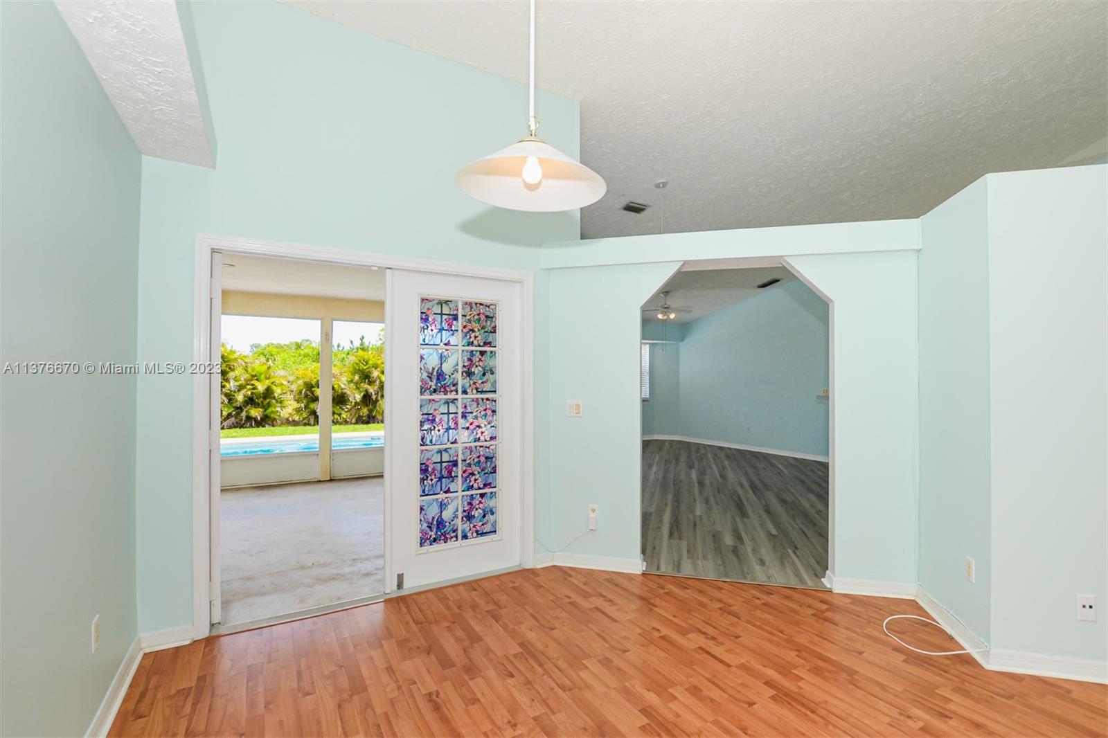 Living Room with French doors to Florida room, pool area