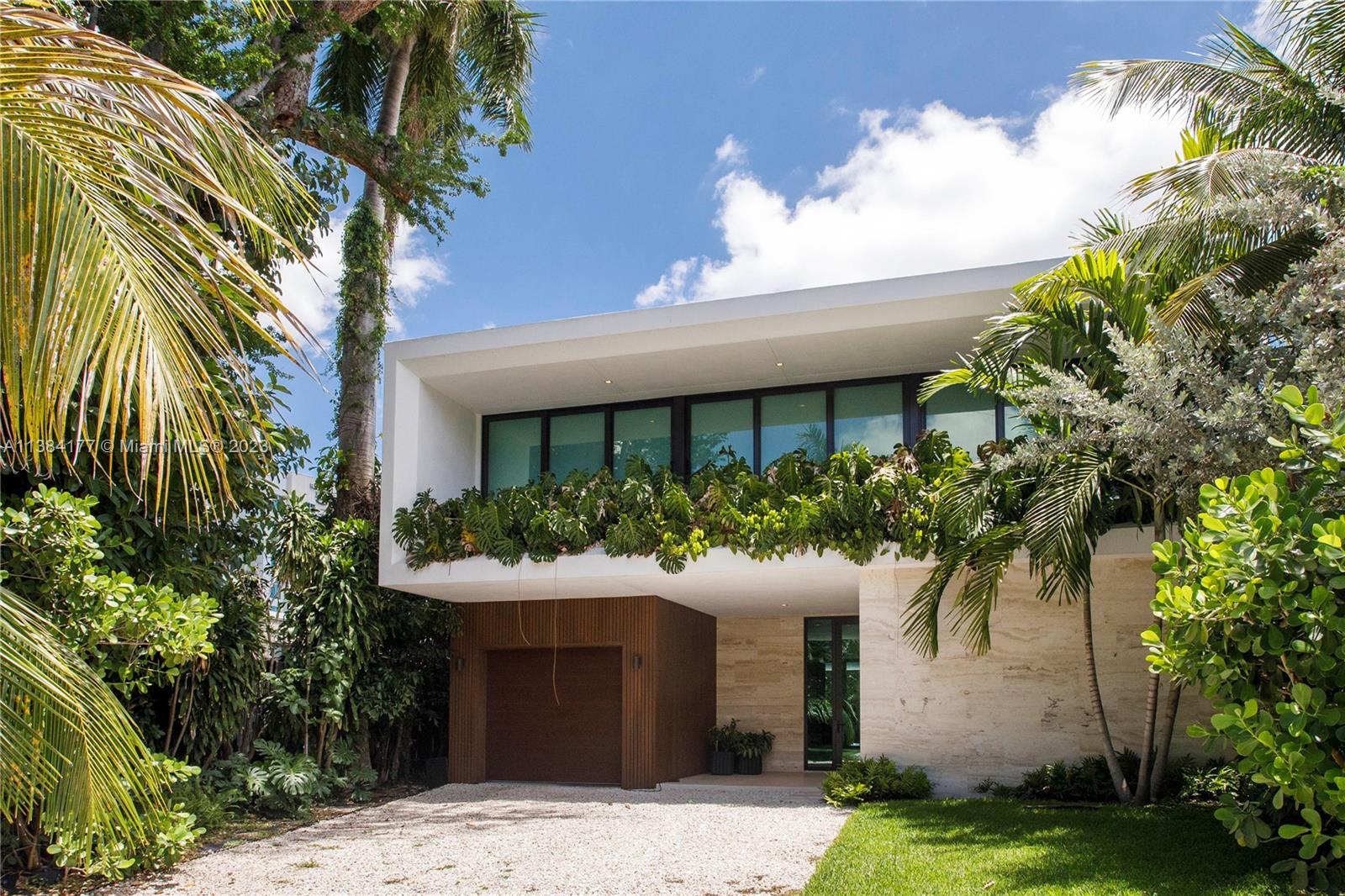 Modern masterpiece located in the heart of Miami. This spacious and comfortable residence offers 5 bedrooms and 5.5 bathrooms, perfect for entertaining guests or for your family's needs. Bright and airy ambiance created by the high ceilings and floor-to-ceiling windows that let in plenty of natural light. Italian designer kitchen is equipped with high-end appliances, flooring, and fixtures, perfect for any aspiring chef. Step outside to your private oasis, complete with a pool, lush landscaping, and a stunning view of Brickell's high rises between palm trees. Covered terrace with a summer kitchen perfect for entertaining guests or relaxing with family. With covered garage for one car and smart home automation throughout the house, this home offers the ultimate in convenience and privacy.