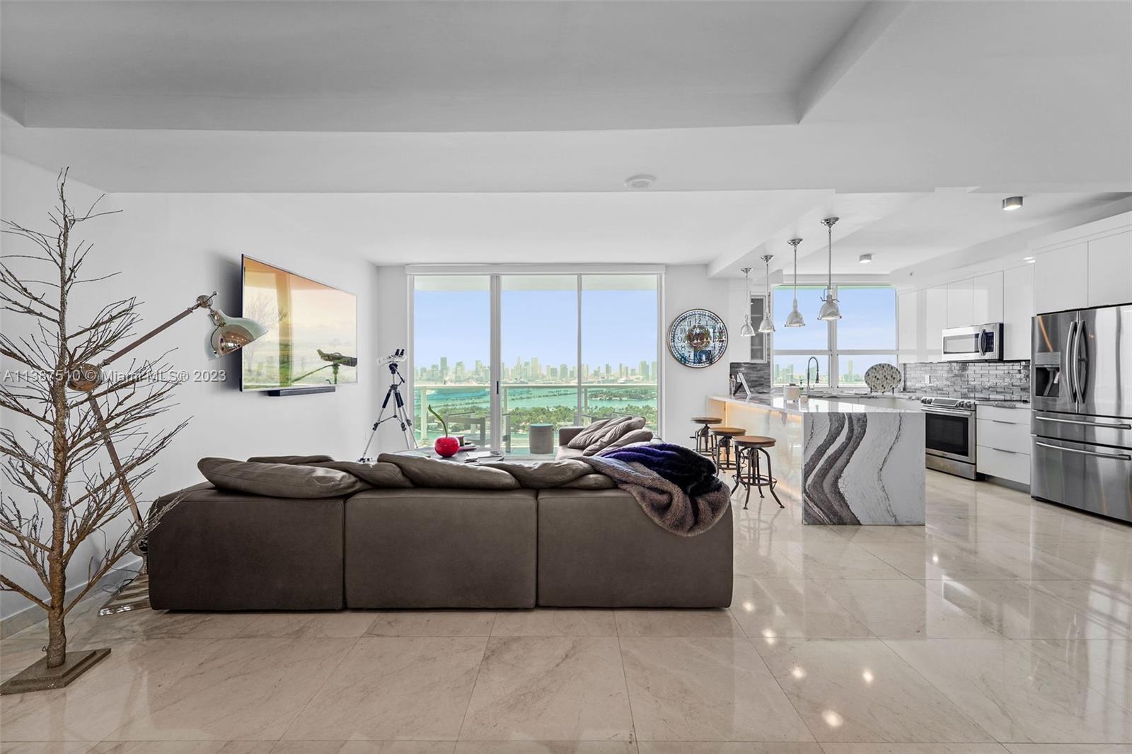 Stunning direct bay views**  Exclusive PH level unit at The Floridian. This floor plan offers expansive skyline views with floor-to-ceiling sliding doors in every room as well,  The higher ceilings are unique to the PH levels. Marble flooring throughout. Kitchen features waterfall island counter with built in wine cooler and stainless steel appliances. Spacious primary suite with private spa-inspired bathroom and large custom closet.  Enjoy e3 separate balconies with private access from living area and both bedrooms.  The Floridian is a bay front amenity-rich building featuring two bay front pools, hot tub, tennis court, gym, market, dock, business center, concierge, 24 security, valet and more. Centrally located near SoFi, Lincoln Road, Whole Foods, Publix, shops, restaurants, and more!