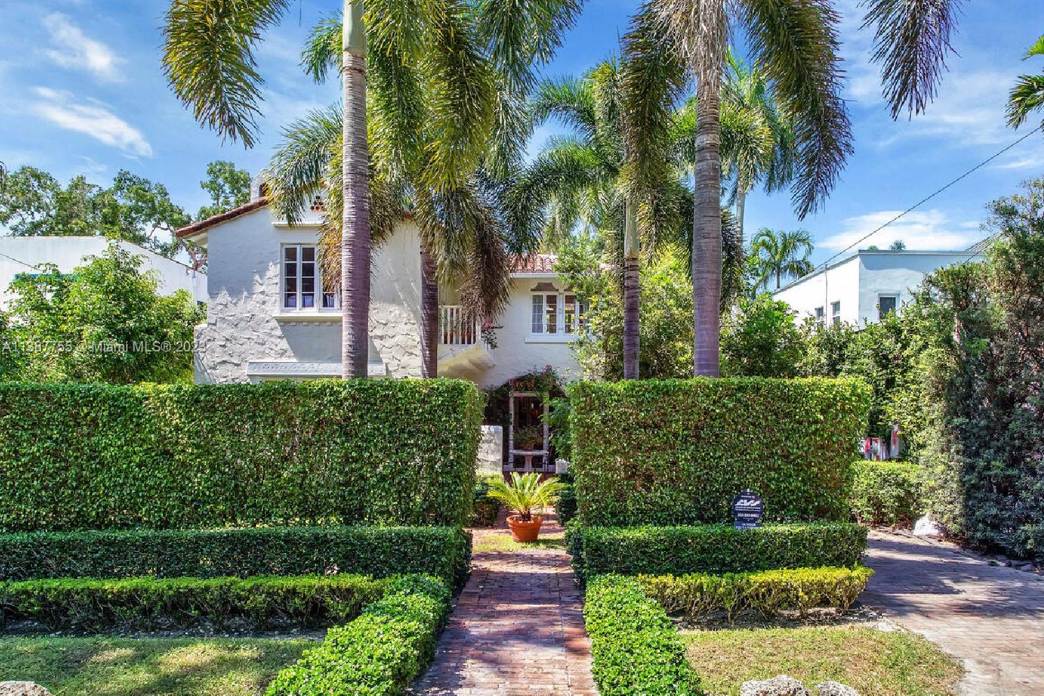 Captivating home on one of the most coveted streets in lush, tree-canopied South Coconut Grove. Walk to the Grove village center’s galleries, boutiques, cafes & bayfront parks & marinas. Light-filled interior spaces with classic architectural details including original wood flooring, 3 fireplaces & volume ceilings. Updated, high-end kitchen features statuary marble countertops, top-of-the-line appliances & separate butler’s pantry. Main house has 3BR’s/2.5BA’s - formal living & dining room + 2 inviting porches for year-round outdoor enjoyment. Two-story guest house offers living area w/mini-kitchen (ideal for poolside entertaining) + 1BR/1BA & cozy enclosed porch. The home is surrounded by an idyllic tropical garden w/vine covered walls, coral rock terraces, native palms & tranquil pool.