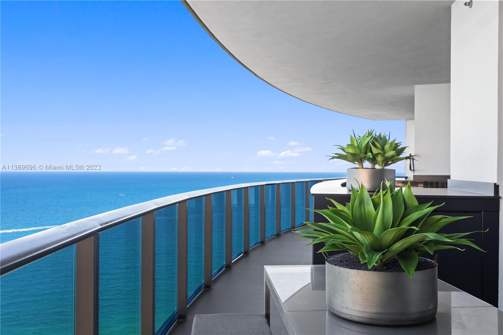 Step into Unit 3005 of the prestigious Porsche Design Tower and be awed by the luxurious residence, fully-furnished by Artefacto. Spanning over 3,100 sqft., this home offers uninterrupted panoramic views of the ocean from each room. With its own carport within the unit, guests can walk directly into their unit and admire the open living room with its Spanish matte black tile flooring, or take a tour of the exquisite Poggenpohl kitchen with its top-of-the-line Miele appliances. Enjoy the summer breeze on the wrap-around balcony, complete with a summer kitchen and plunge pool. Each bedroom is equipped w/ custom hardwood floors and closets from Ornare.Other amenities include sports simulators, a spa, wine storage, sunset deck, lounge, game room, fitness center, pool, billiard room and more.