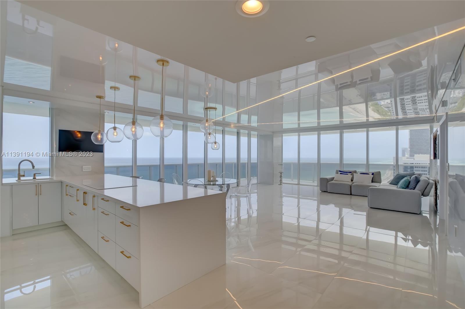 Welcome to the pinnacle of elegance and sophistication at Beach Club Two's newly renovated corner apartment. Designed to perfection, this southeast-facing residence in the most coveted line 02 offers the most desirable features. Step inside to be greeted by a false ceiling with ocean reflections mesmerizing strip lighting, creating an enchanting ambiance reminiscent of a two-story dwelling. Prepare to be captivated by breathtaking ocean views from the expansive wraparound terrace, while indulging in the luxury of hight floors and hurricane high-impact windows throughout. Unwind and rejuvenate in the resort-style oasis that is the Beach Club community, where five infinite-edge pools, a world-class fitness center and spa, complimentary beach service, and unwavering 24-hour security await.