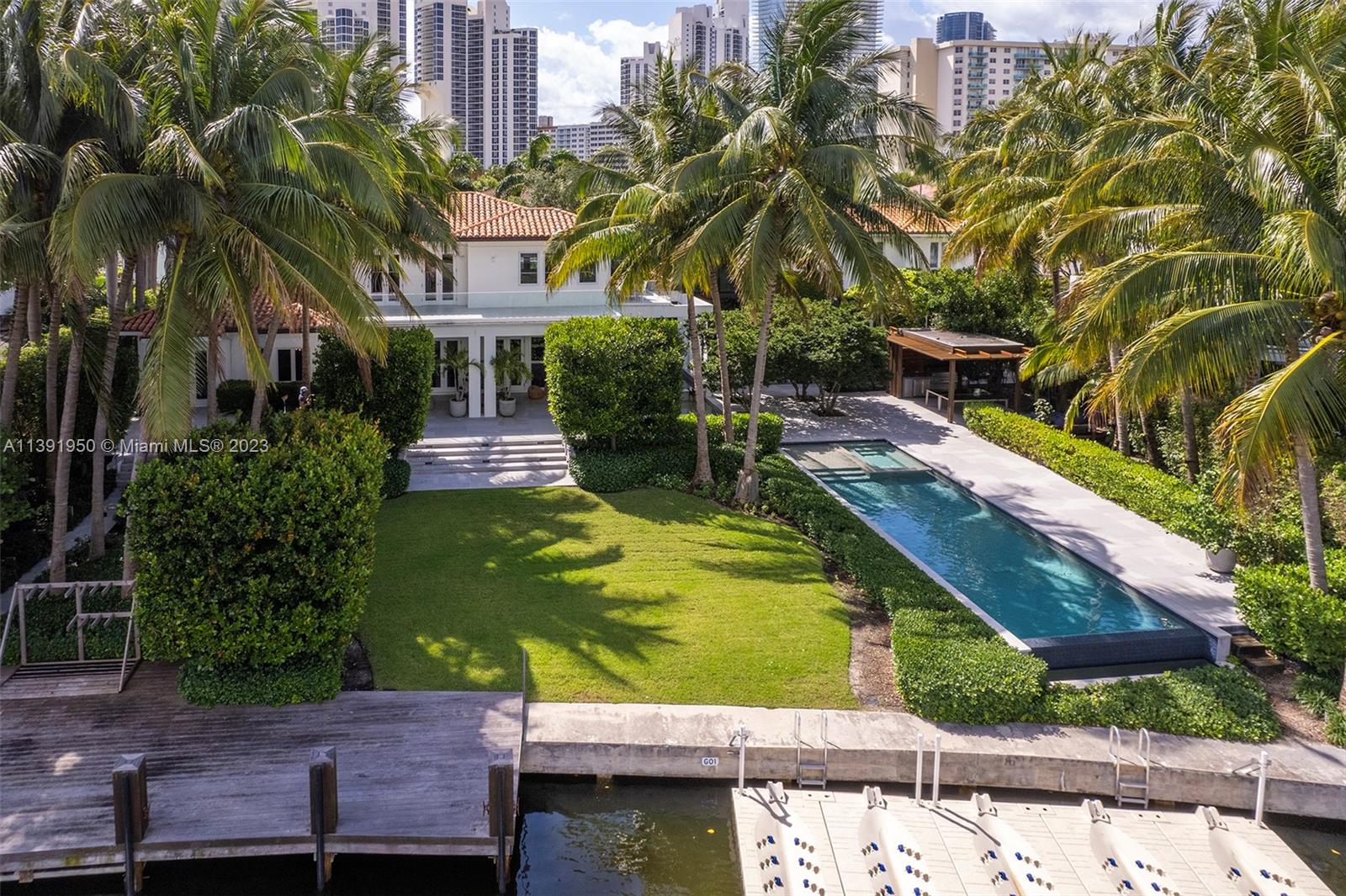 Welcome to the epitome of luxury and privacy in Golden Beach: a sprawling near 26,000 sqft waterfront estate, featuring a bespoke 7,500+ sqft home. Unmatched in its grandeur, this one-of-a-kind property offers a sanctuary that's nothing short of your own universe. Concealed behind majestic hedged walls, tranquility reigns in this immaculate, custom-designed paradise. The sleek design infuses every turnkey room, reflecting opulence and meticulous attention to detail. Embrace serenity in the massive backyard, offering a private deep-water dock and unparalleled water vistas. All within walking distance to the exclusive private beach and nine enchanting parks. Your timeless haven awaits.