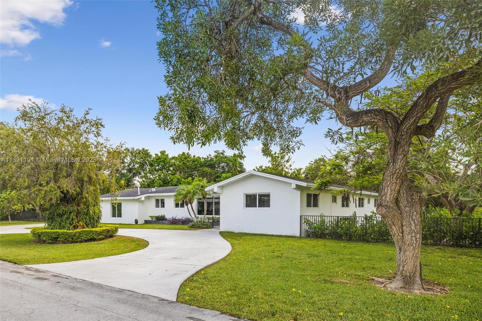 IMPECCABLE PINECREST HOME READY TO  MOVE IN! This inviting 4 bdr 2 bath pool home is filled with sunlight brightening every room thru the high impact windows and doors. Top of the line remodeled white kitchen passing to the open floor plan of dining and living areas with soft neutral tiles and white walls in all areas of the home. Black out and roller screen curtains The garage has been remodeled into a multi purpose space with a/c, paddle fan and recessed lighting. Laundry in garage is behind private doors and big attic. The open air pool calls you to take a dive or relax on the covered patio. This huge fenced back yard (0.52 acres) on a very quiet private street. Circular driveway for up to 10 vehicles. Pets under 15 lbs