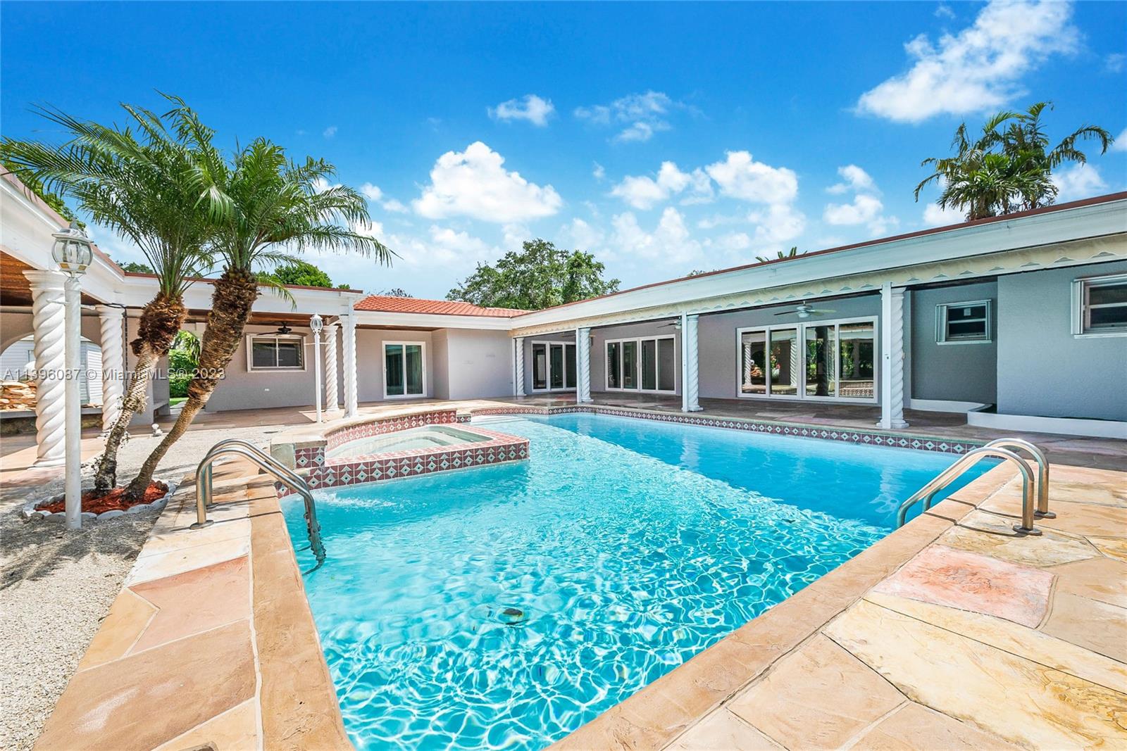 This property encompasses over one acre of land and is adorned with lush landscaping, flourishing fruit trees, a refreshing pool, and a delightful pond featuring a calming waterfall. The master bedroom suite provides a tranquil escape, boasting its private sitting area overlooking the pool and an impressively spacious walk-in closet. The tastefully renovated kitchen, completed in 2017, highlights contemporary stainless steel appliances, elegant granite countertops, and enough seating for over 10 guests, making it ideal for hosting memorable gatherings. The residence boasts an inviting open floor plan. With an abundance of space, this property offers ample room for living, working, and recreation, ensuring your every need is met.