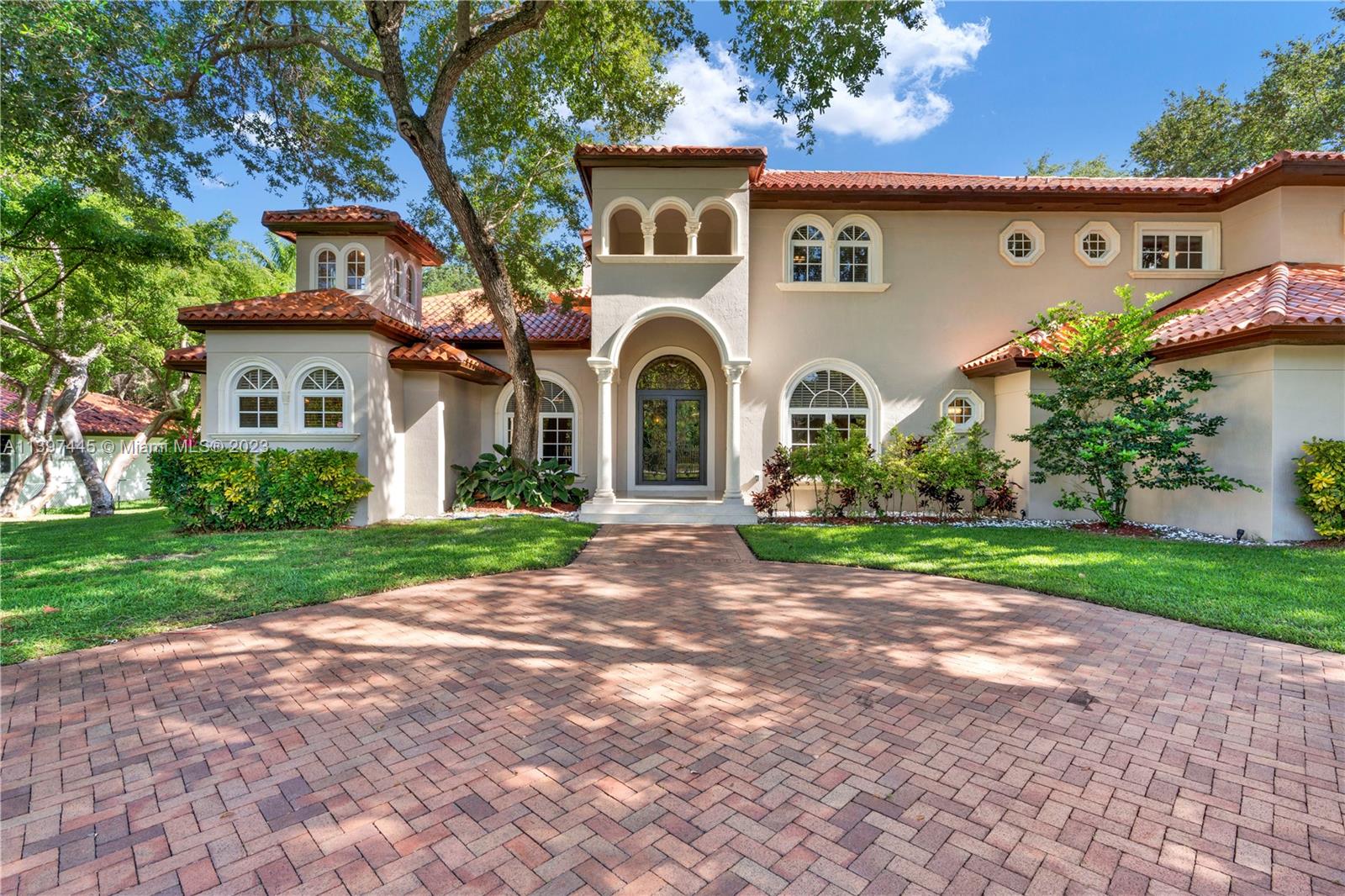 Mediterranean Perfection! Prepare to be wowed as you step inside this spectacular home nestled among mature oak trees. An elegant foyer opens to soaring 20’ ceilings in the natural light-filled great room, w/ wood burning fireplace, & wrought iron stair railing overlooking tropical backyard pool/waterfall. Luxurious owners suite w/spa bath & exercise room, an office & guest bedroom downstairs, plus 3 ensuite bedrooms upstairs. Gourmet kitchen w/ custom cabinetry, Subzero, Wolf, & Bosch appliances opens to spacious eat-in area & family room w/ views of pool/lush landscaping. Not a detail was missed. Hop on bordering paths steps away from Coral Reef Park, Deering Estate, & top-rated public/private schools. Who is ready to call this elegant, private, and sophisticated house, home?