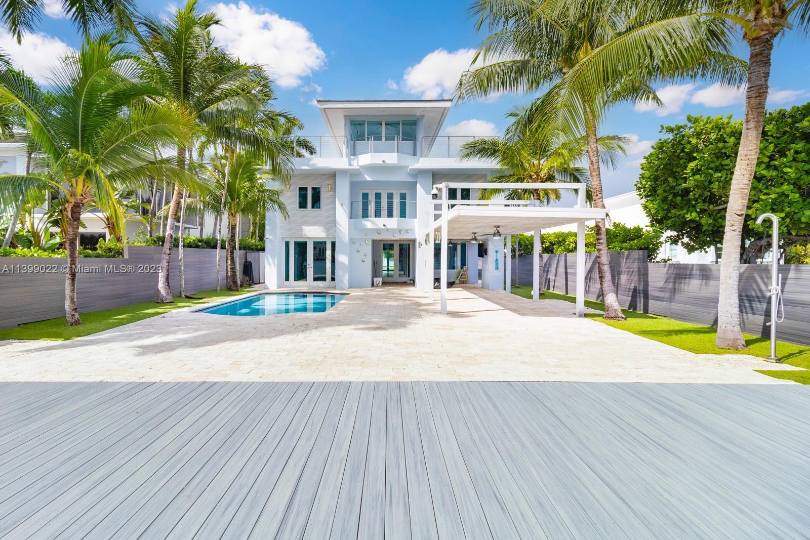 This spectacular waterfront home has been totally renovated with a construction upgrade of a new entrance and third floor railings in 2019. All the bedrooms are in suites and facing the open bay. 5bed 5 1/2 bath with rooftop terraces. 36 x 24 CARIBBEAN BLUE marble & wood floors throughout. Beautiful kitchen with top of the line appliances, granite counter tops, impact windows, storage room, sound system, brand new back-up generator installed in 2023, solar heated pool, new dock and new 50 linear foot seawall. New floating lift that holds up to 25, 000 lbs, and a floating dock for 2 jet ski. The Second and third floor of the house were built in 1989. With breathtaking views this beautiful property is ready for a new owner. Come enjoy the gorgeous view of the bay, Venetian islands and Miami.