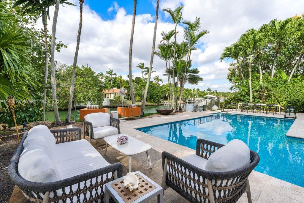 Spectacular 5,681 SF contemporary home on the Coral Gables Waterway, with 5 bedrooms and 5.5 bathrooms on an expansive 15,730 SF lot. Its modern design aesthetic is characterized by a spacious floor plan which seamlessly extends to the outdoors, allowing abundant natural light to illuminate the entire home. A well-appointed eat-in kitchen boasts high-end appliances, custom cabinetry, and an exquisite island, flowing beautifully to an outdoor dining area. Impressive features include a marble staircase, impact windows and doors, and a family/game room complete with a wine cellar and wet bar. Outdoor entertainment areas include a heated saltwater pool, fire pit, grill area and a dock with boat lift. Close to Riviera Country Club.
