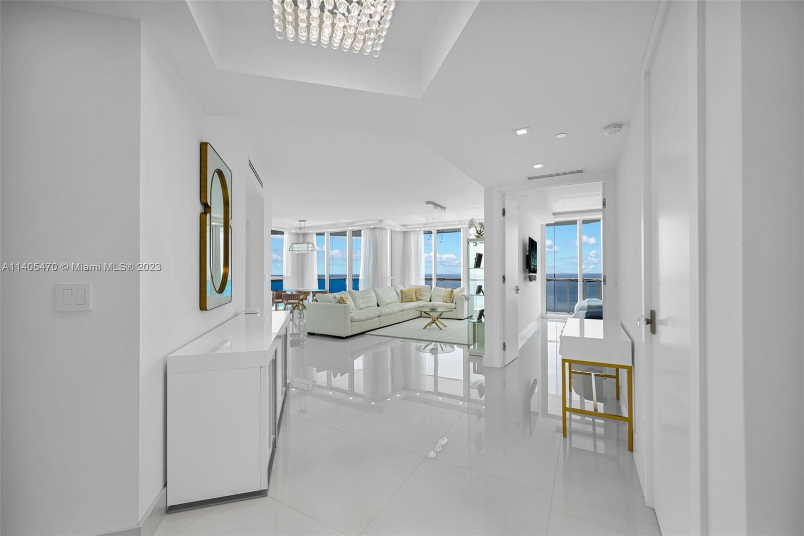 Welcome to this beautifully remodeled Penthouse that has undergone a complete transformation with direct ocean and city views. This turn-key features an open floor plan with an abundance of natural light flowing through impact hurricane oversized windows. With 10 feet ceilings, custom closets and lighting, beautiful white porcelain floors create an inviting ambiance, perfect for gathering with family and friends. Custom modern kitchen, with a large central island, is the heart of the space, marble countertops, café appliances. The adjacent dining area offers ample seating for family meals or entertaining guests. True Luxury Resort Style Living within a building that features; Full Service Private Beach Club,  private restaurant, café, 24 hour security, concierge , valet.