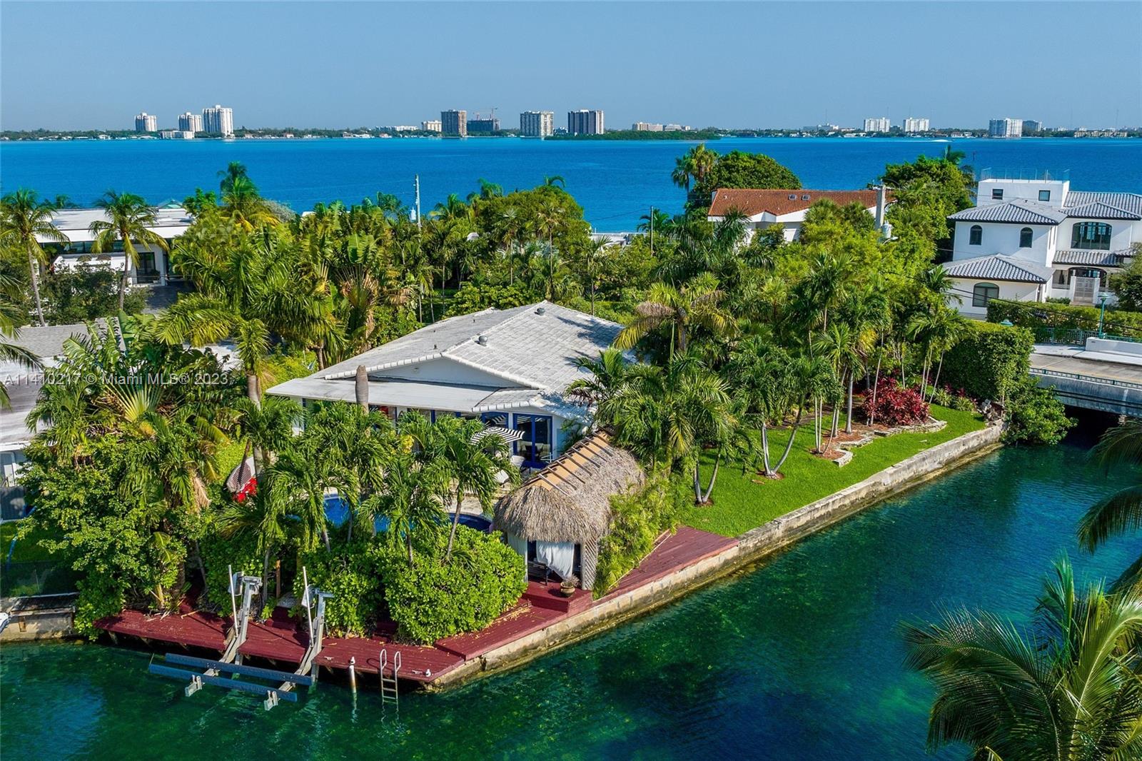 Discover a rare gem in Miami Beach’s exclusive Biscayne Point Island! This 3-bed/2-bath home offers 2,525 sqft of luxurious living. Set on a private, oversized corner lot, you’re surrounded by lush tropical foliage to maintain privacy. Enjoy immediate access to Biscayne Bay, with a dock and boat lift. Outside, an outdoor oasis awaits with a heated pool, wet bar, tiki hut, Argentine grill, and inviting patios. Inside, a spacious floor plan with an open kitchen and ample living areas. The master suite overlooks the pool, with a Moroccan sauna tub adding a touch of elegance to the space. Minutes from SoBe and Bal Harbour, this exclusive property is a must-see.