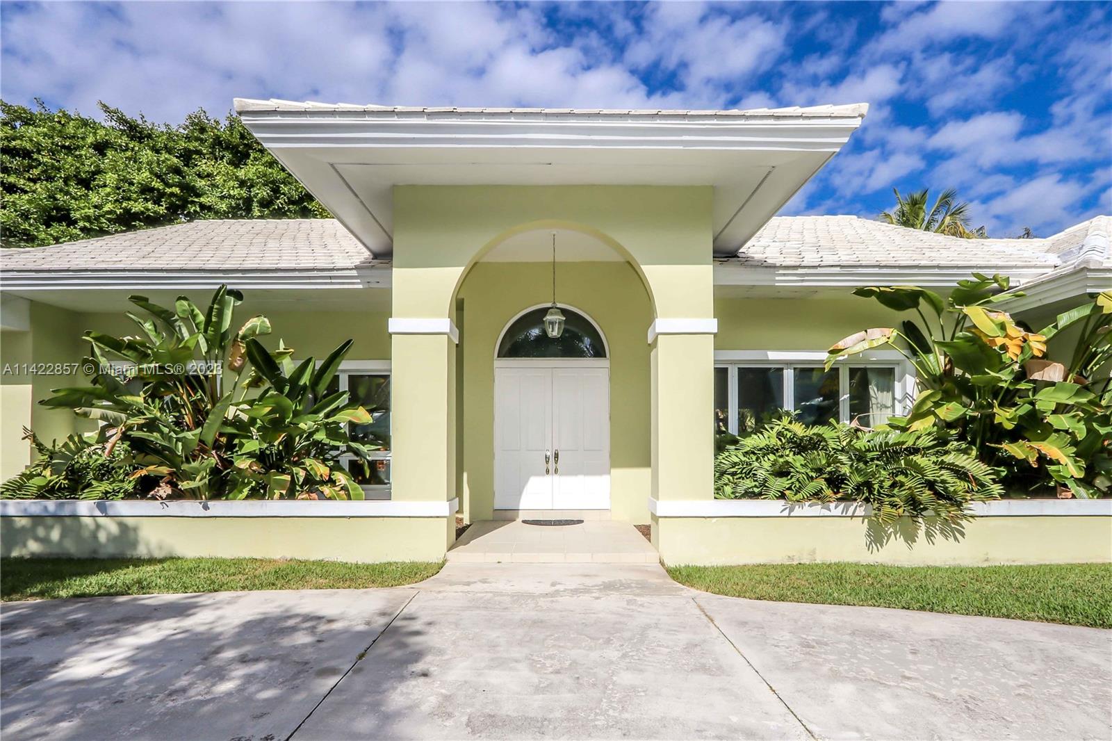 Pinecrest Pristine! Beautiful contemporary Florida home situated on an expansive builders' acre lot in the prestigious Village of Pinecrest. This furnished 4 bedroom, 4 bath has two additional bonus spaces including an office and large playroom for 3,722 SF of living space. Enter through double doors to vaulted ceilings with a central fireplace connecting the open-concept living, dining, kitchen, and family room. Plentiful windows and glass doors open up to the patio featuring an extra-large 55-foot swimming pool, an exquisite banyan tree, and a lushly landscaped backyard paradise. Pool and lawn service are also included. Hop on bordering paths steps away from Pinecrest Gardens & top-rated public/private schools. Who is ready to call this lovely Pinecrest gem, HOME?