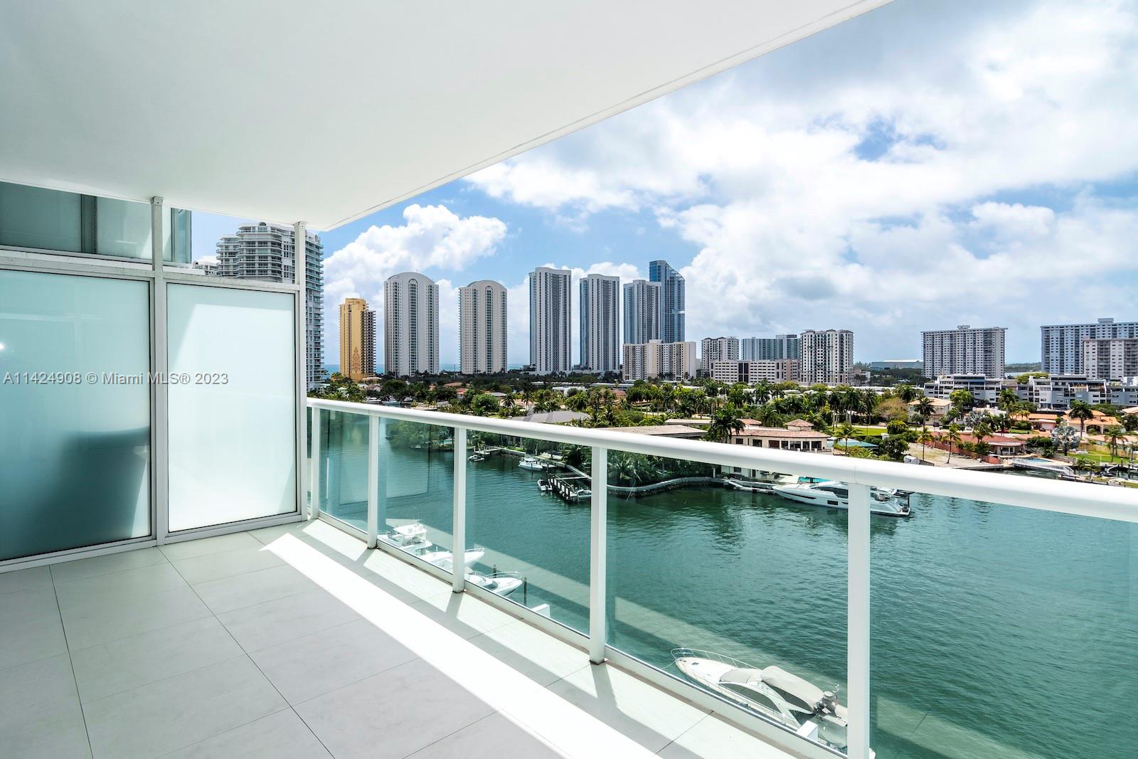 Stunning Waterfront Retreat! Discover this exquisite 3-bed, 2.5-bath designer condo with breathtaking water views. Adorned with white glass tiles throughout, it exudes modern elegance. Indulge in unlimited amenities: infinity pool, jacuzzi, cabanas, spa, fitness center, tennis court, and a fantastic restaurant. Walk to the beach or take the shuttle. Enjoy a perfect blend of comfort and style. Relax by the bay or indulge in watersports. Live the waterfront dream - call for a private tour today!