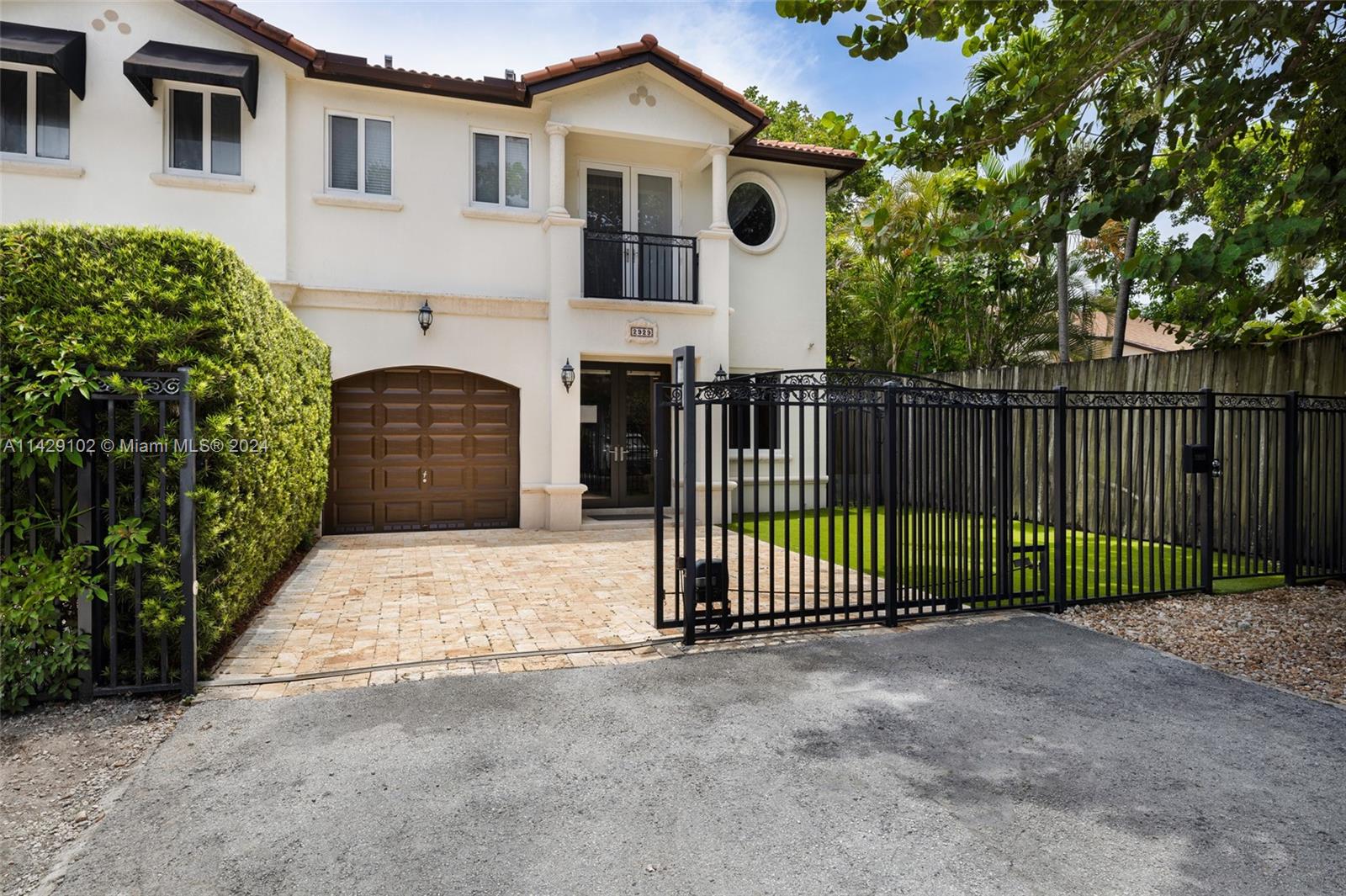 Lovely gated townhome on a quiet, tree-lined cul-de-sac in prime center Grove location. Walk to trendy boutiques, galleries, cafes, highly rated schools and bayfront parks & marinas. Light-filled, open concept living spaces feature volume ceilings, crown mouldings and porcelain tile flooring throughout. Custom kitchen w/ wood cabinetry, stone countertops & stainless appliances. Impact windows & doors. 2nd level offers 3 bedrooms including a large master suite w/ walk-in closet and private balcony overlooking the tree-tops. The home also features a 1 car garage + an upgraded AC w/ AirScrubber system for surface & air purification.  The private garden is ideal for outdoor living & entertaining. Just minutes to Metrorail, Coral Gables, downtown, Key Biscayne & the Beaches.
