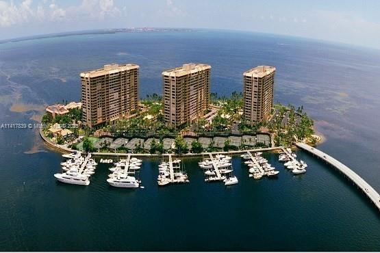 Located in private Grove Isle community. Unit offers the largest floor plan with 3 bedrooms, 2.5 bathrooms, and a maids/guest room. Watch wonderful sunrises and sunsets from two ample balconies. Amazing panoramic water views and stunning white marble floors create an elegant living environment. The open Eat-In kitchen features top-of-the-line appliances and custom cabinetry for style and functionality. Located at 1 Grove Isle Dr, this residence offers not only exquisite interiors but also access to the exclusive Grove Isle community. Residents can indulge in a range of amenities, including a private beach, marina, swimming pools, tennis courts, and a fitness center. The surrounding lush landscape enhances the overall tranquility and beauty of this sought-after address.