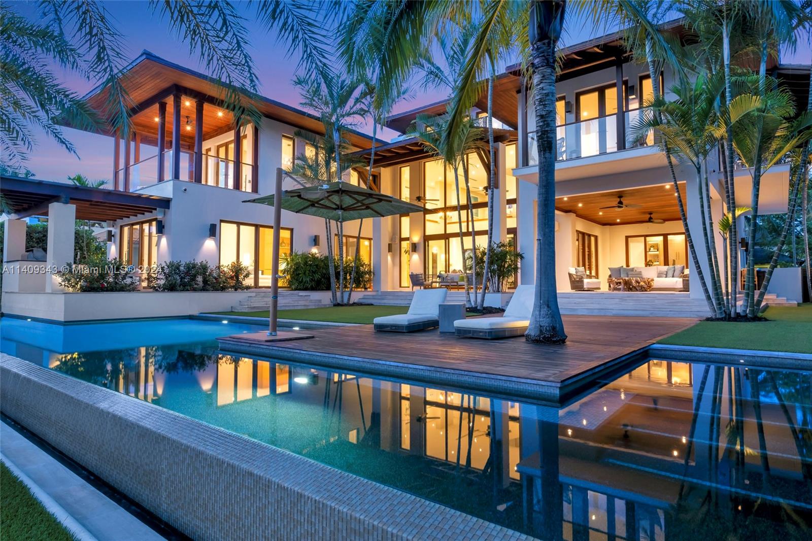 Welcome to your luxury waterfront home in paradise with beautiful natural stone and wood throughout, an updated kitchen and bathrooms, two-story living room, 5 bedrooms plus bonus 6th bedroom on 3rd floor, 6.5 bathrooms with panoramic views from your third floor. This custom Cesar Molina, world renowned architect and design firm, is designed to make your lifestyle exceptional and feel like you are living on a resort. The home was fully refreshed and rejuvenated in 2022 with many upgrades and luxury finishes. The unparalleled indoor outdoor living spaces invite entertaining and living the island lifestyle. Dock your yacht behind the house with less than a 5-minute boat ride to Biscayne Bay. Enjoy the 9 covered balconies and 4 covered terraces while you swim laps in your infinity lap pool.