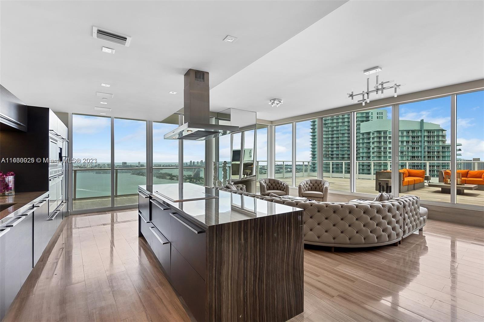 An absolute one of a kind designer Penthouse perched over Biscayne bay with sweeping 270 degree views from the Miami Beach shoreline to the downtown skyline; from Coconut Grove to the Hard Rock. In a world of cookie cutter Miami apartments, this glass jewel box stands alone. With 2,700 sqft of interior space and over 2,500 sqft of sprawling terrace directly off your great room, it is a unicorn that will never be repeated. Imagine the beauty of opening your glass sliders to an immense outdoor living space replete with a jucuzzi hot tub and outdoor kitchen. A home in the sky filled with designer finishes, a spectacular glass primary bath, oversized walk in closets and a gorgeous chefs kitchen and entertainment island. It's one of those spaces that must be experienced in person to be believed