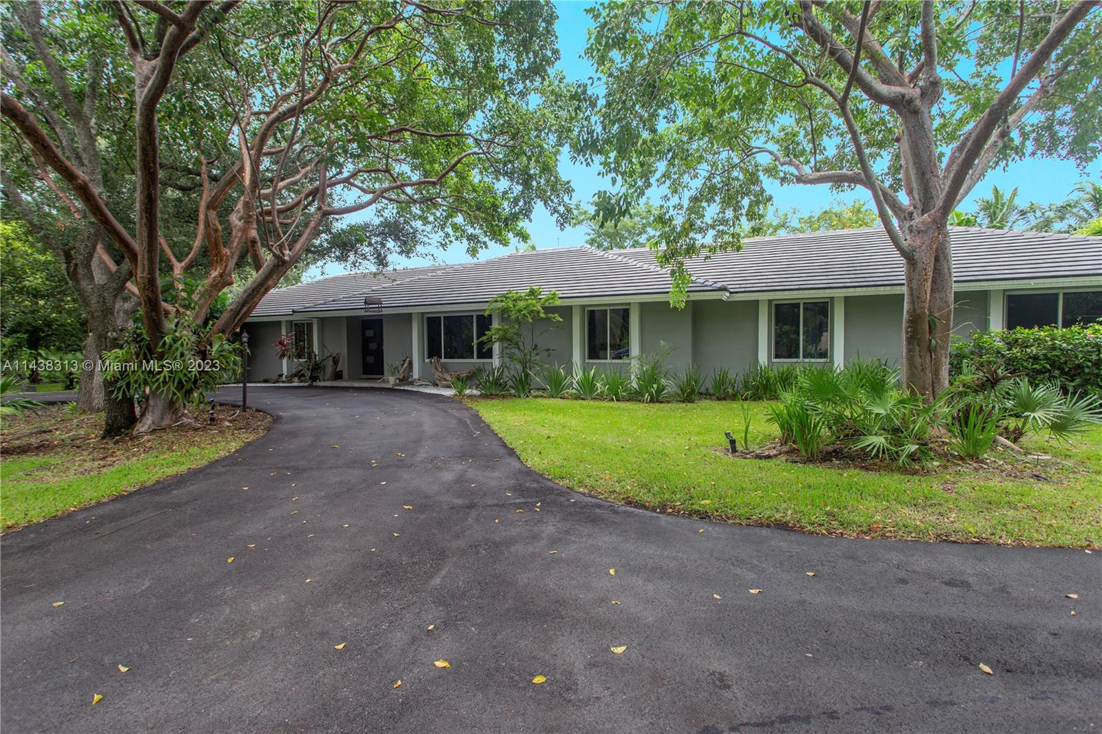 Fully Renovated 5 bed / 4 bath one story home in Palmetto Bay on over 3/4 of an Acre! This modernized estate features a large open plan, perfect for entertaining and family gatherings. Living room, family room, and dining room are all conveniently located right off of the kitchen. A wet bar is conveniently placed by the family room and dining room. The open kitchen features a beautiful blue stone countertop. Your impressive primary suite has a large walk in closet and a tastefully appointed bathroom. Exterior features gated entry, large driveway, 3 car carport, fruit trees, mature landscaping, and plenty of yard space on either side of the home. Other ftrs: 2 car garage, impact windows & doors, Roof 2021.