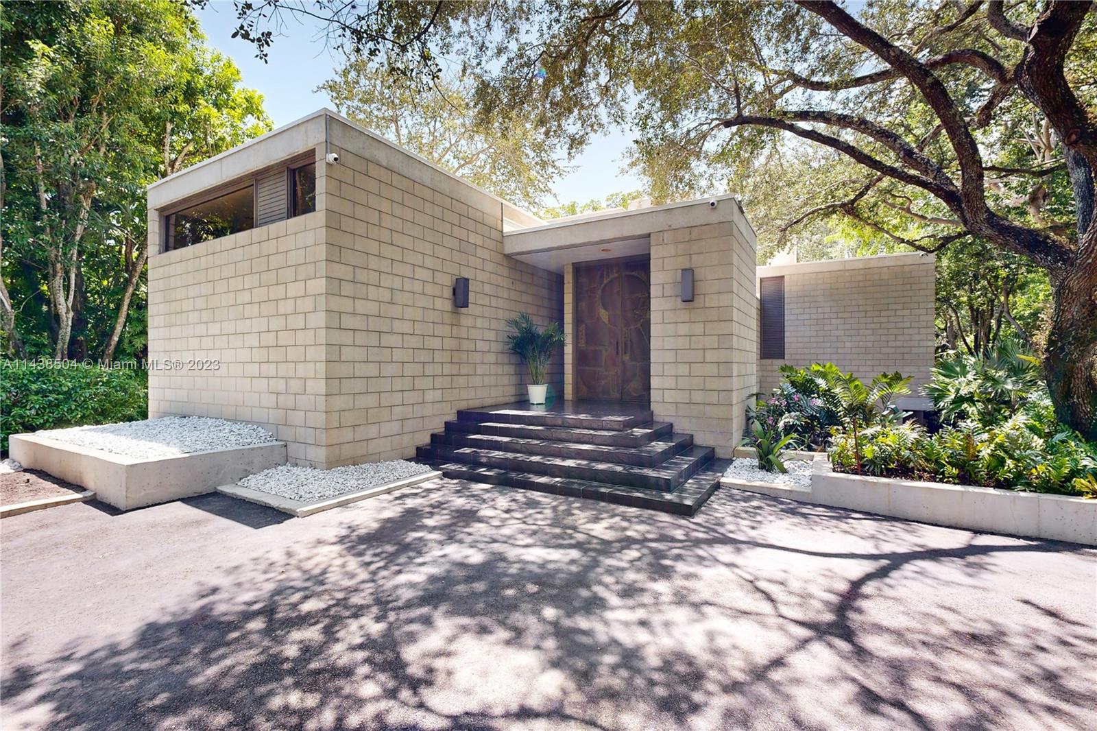 Spectacular 4 bed/4bath/2 half bath, 5,332 sf contemporary home surrounded by a "Lush Tropical Oasis" in the exclusive community of Devonwood in Pinecrest. Open kitchen with new Viking stove top w/counter bar opens to grand family rm. Primary bdrm on 2nd level w/enclosed balcony features large office/loft overlooking expansive living room with fireplace. Volume/high ceilings with impact windows and drs. Ample natural light illuminates interior w/garden views in every rm. 3rd level bedroom with roof deck ideal for stargazing.  3 newer A/C units and upgraded baths. New roof and 1000 gal prop generator added in 2019.Tranquil open patio terrace Zen-like feel w/garden pond for Yoga or entertaining. FHP security patrolled.