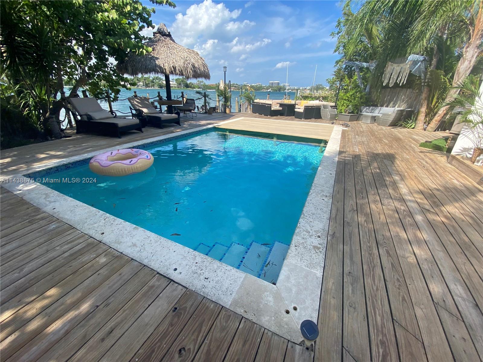 Beautiful wide bay views with Indian Creek Island in background, no bridges to bay, 4/4 pool home near cul de sac in a small gated Miami Beach (Nobe) community. This house has the original master on the ground floor, and a huge master suite with a spa bath/ separate shower and large closets on the second floor, with a big balcony. Kitchen has granite counter tops and stainless appliances, including a double oven. Watch dolphins and manatees from the backyard. Plenty of off street parking and a one car garage. Plenty of storage. Heated pool. Sandbar wishing swimming distance and Haulover cut just a kayak trip away. Walk to the beach, Stillwater dog park and playground and North Beach Oceanside Park (the largest park in Miami Beach). Best price wide bay view in walking distance to the beach!