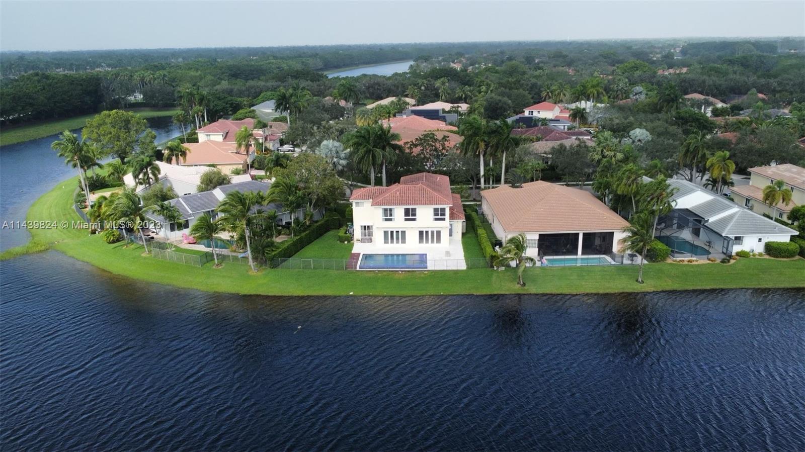 Stunning contemporary waterfront home sitting on an oversized lot with unobstructed & impressive wide water views. This Modern Residence features 3 Elegant en suite bedrooms Upstairs & Loft and One Spacious Bedroom or Office downstairs. Master Bed is refined with spacious, & custom build his/her closets.ROOF WAS DONE 2012. 
Master bath with his and hers, Sauna & light therapy jacuzzi. Spectacular Gourmet kitchen with Sub Zero & Wolf appliances, quartz counters, high-end water features and state of the art lighting, all overlooking the lake & pool area. This Smart and Modern Residence features custom impact windows +electric hurricane shutters, luxury Marble Floors in lower floor and hardwood floors upstairs, High Ceilings, Floor to ceiling windows. Cypress Bay High School. A+ Schools.