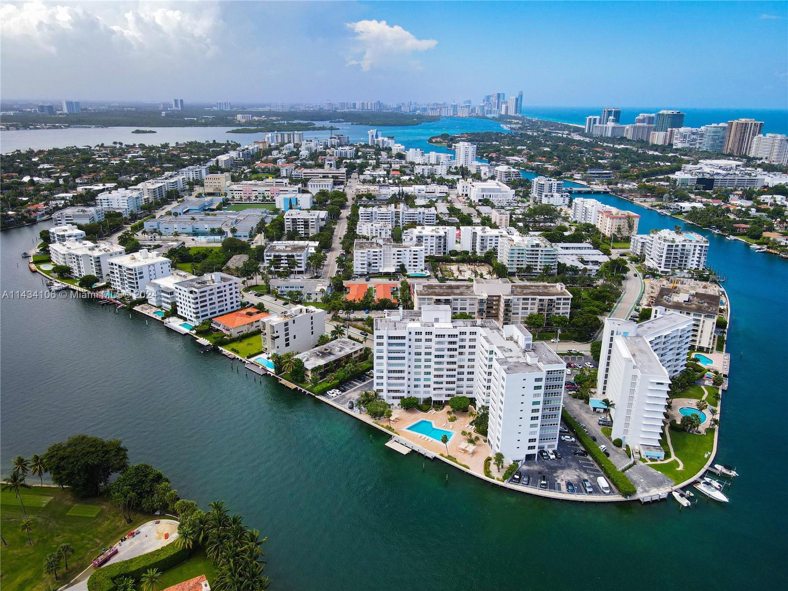 Welcome to one of the most fabulous CORNER units in Bay Harbor Island. With unobstructed views of the Indian Creek canal & golf course, this 2 beds| 2,5 baths PLUS DEN unit has been completely remodeled featuring a fabulous open kitchen that overlooks the water, wraparound windows in the living room, spacious open floor plan, 2 individual suites each w/ it’s own bathroom, (master suite w/ 3 separate walk-in closets) and Washer & dryer in unit. With exquisite views + lots of sunlight, this is the perfect place to call home! Den is currently set up as an office but can be used as a third bedroom. 
Addtl. features include all impact windows, tile floors throughout, lots of closet space and 1 assigned storage unit.  Building amenities include a pool, gym and secured lobby. Easy to show.