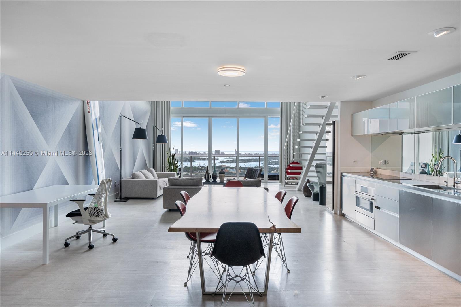 A truly unique, one-of-a-kind home in the sky! Welcome to unit 3202 at TMP, this designer finished 2 bedroom / 2.5 bath loft with over 1,802 S.F. featuring an oversized private 10x 20 terrace to enjoy some of the most stunning views one could find of Miami Beach, the Atlantic Ocean, Biscayne Bay, Downtown and on a clear day all the way to Sunny Isles. Finished with timeless large format, vein cut travertine flooring throughout including terrace, custom wallpaper by acclaimed fine artist Johnny Robles, a Bosch induction cooktop, a Bosch under counter convection microwave/oven combo, polished S.S. switch plates as well as a mirrored kitchen backsplash and more. TMP is a full-service luxury building, with fitness center, Clinique La Prairie Spa and S. of 5th private beach club membership.